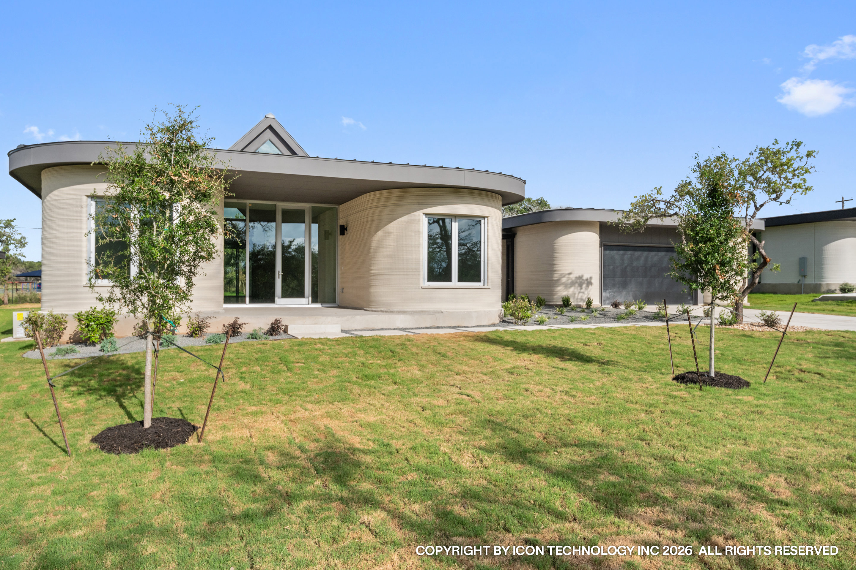 Finished 3D printed concrete home at Wimberley, Texas, front facade in a natural hill country setting